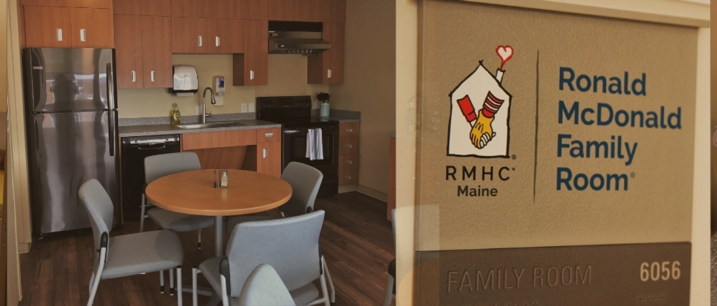 A cozy family room with a kitchen area, table, and Ronald McDonald House logo visible.