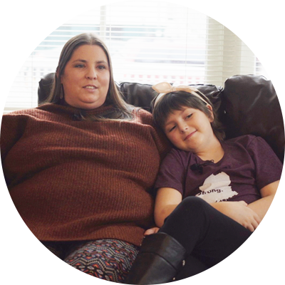 Kym & Melanie sitting on a leather couch